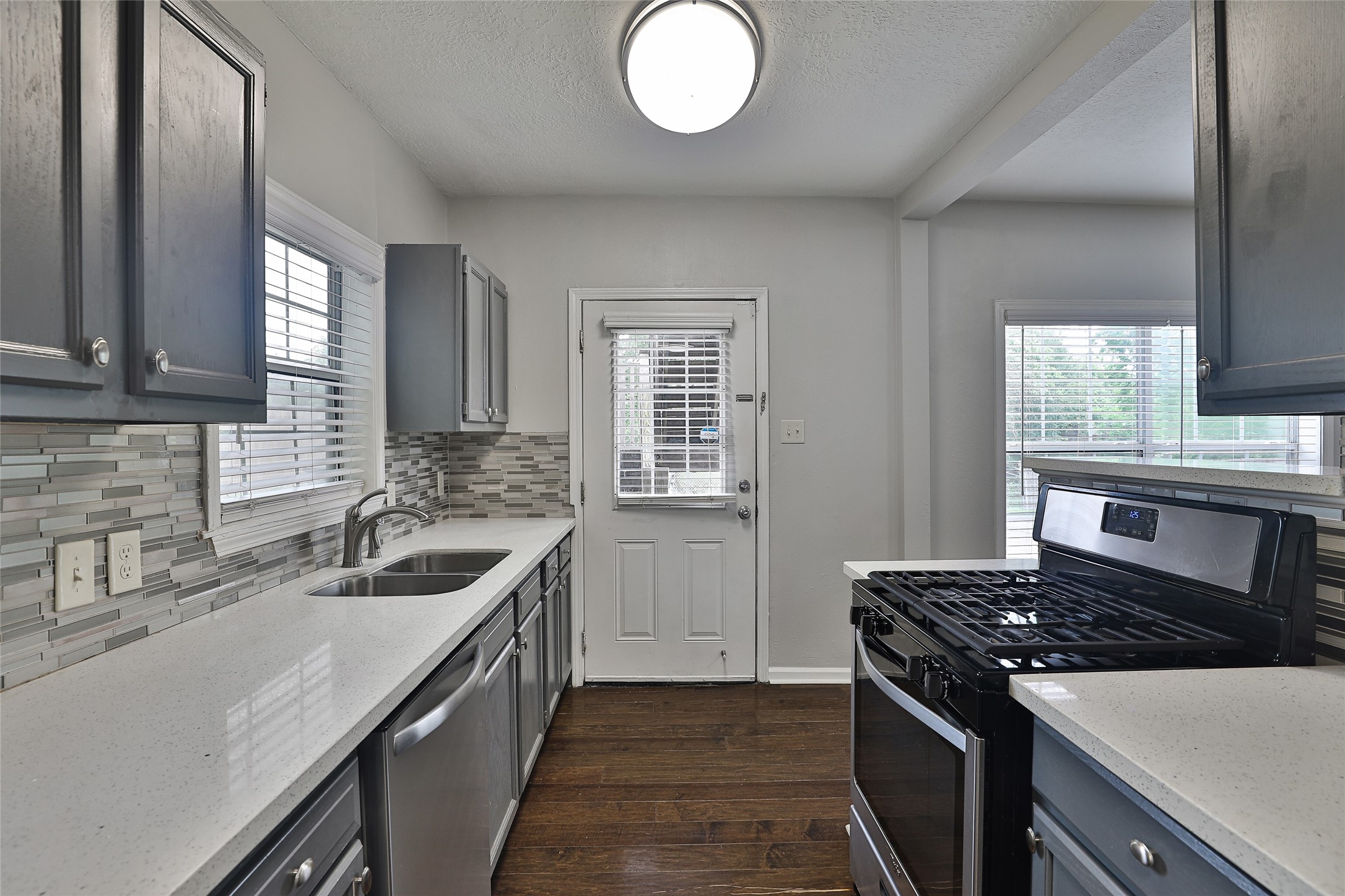 5009 Polk Street Houston, TX 77023 - Photo 14 of 16 a kitchen that has a sink and a stove