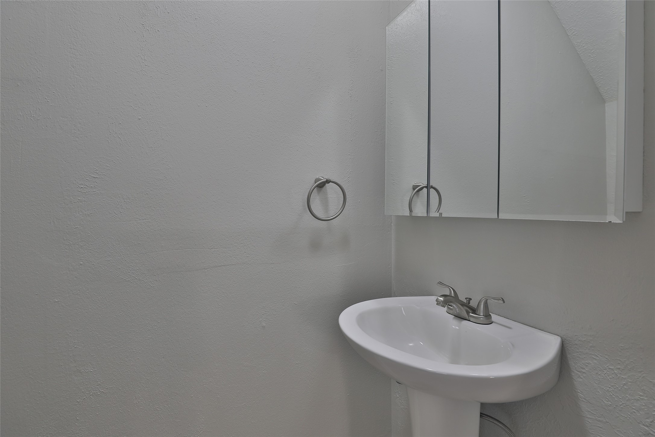 5009 Polk Street Houston, TX 77023 - Photo 15 of 16 a bathroom with a sink and mirror
