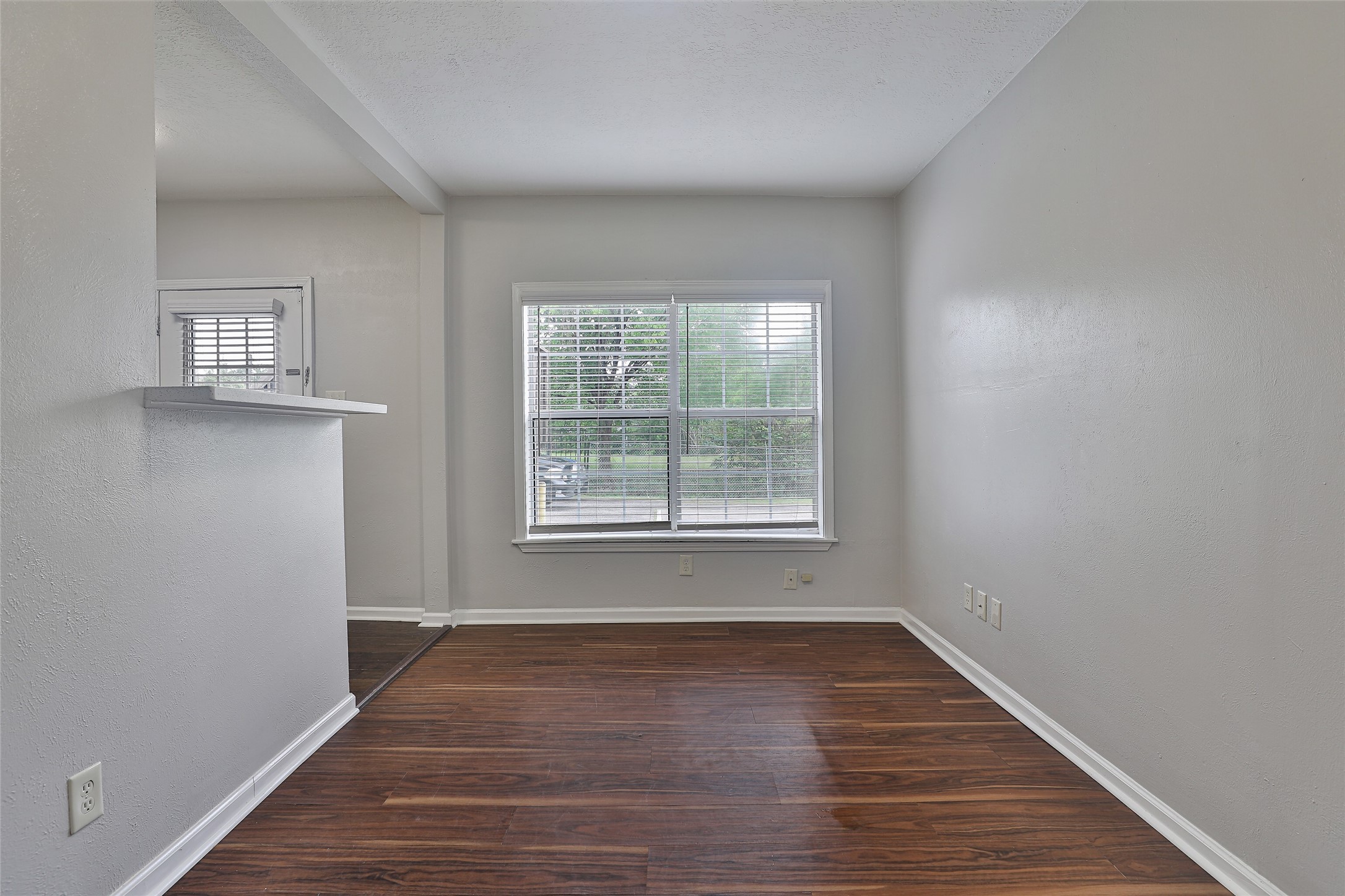 5009 Polk Street Houston, TX 77023 - Photo 5 of 16 a view of an empty room with wooden floor and a window