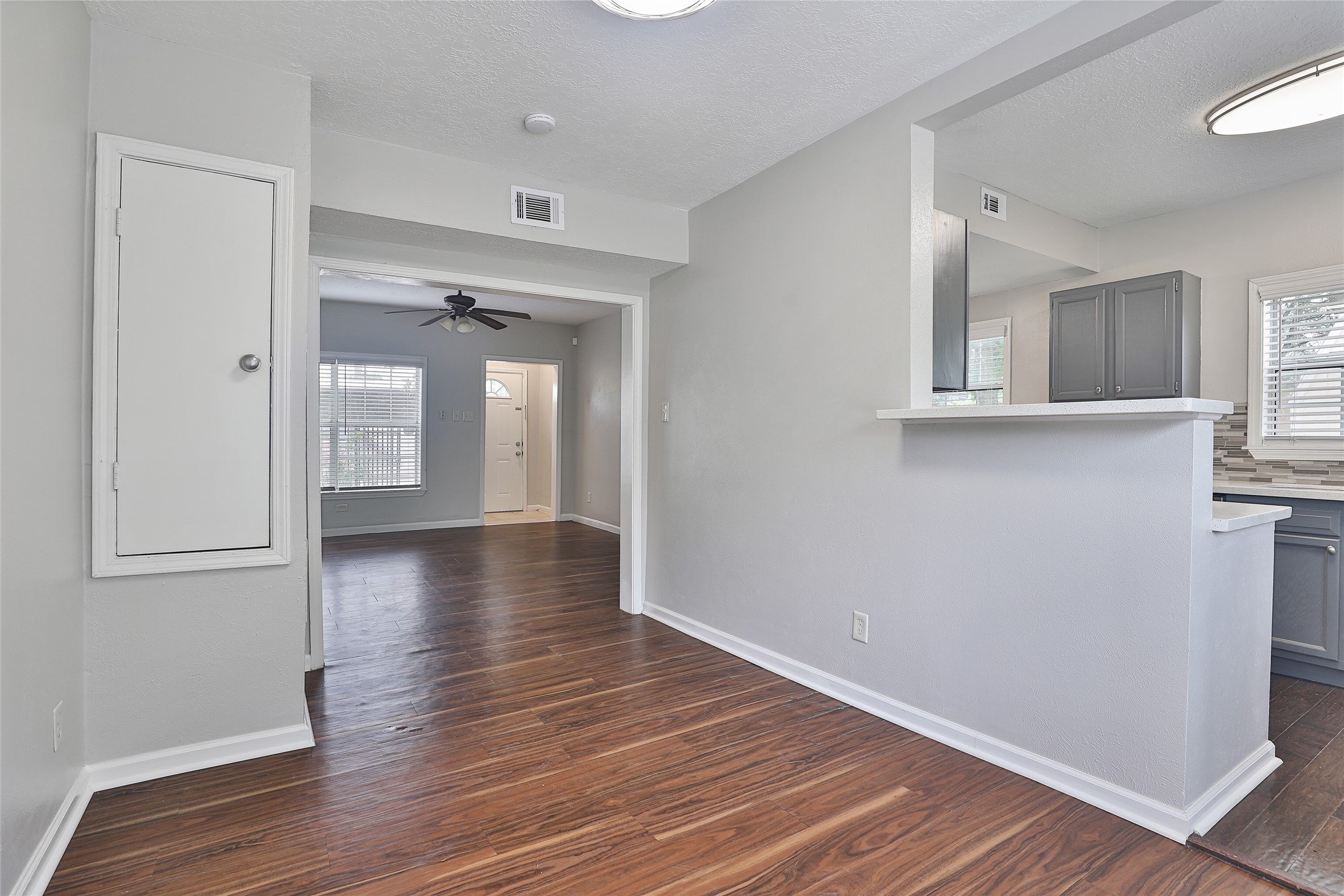 5009 Polk Street Houston, TX 77023 - Photo 6 of 16 an empty room with wooden floor and windows