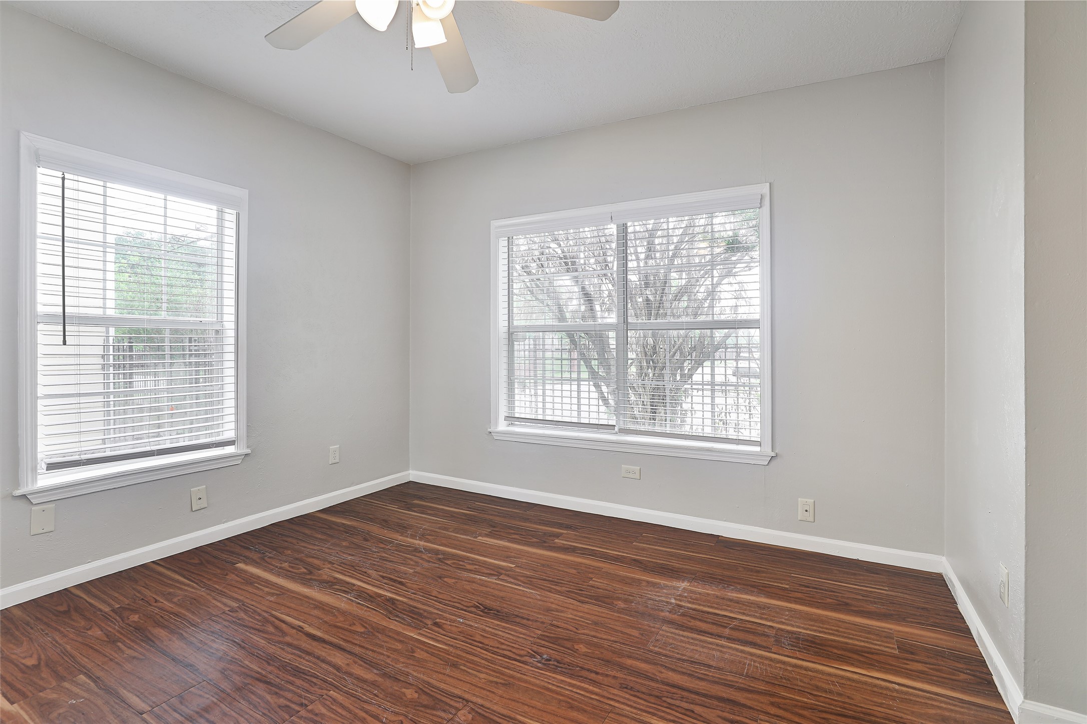 5009 Polk Street Houston, TX 77023 - Photo 7 of 16 a view of an empty room with wooden floor and a window
