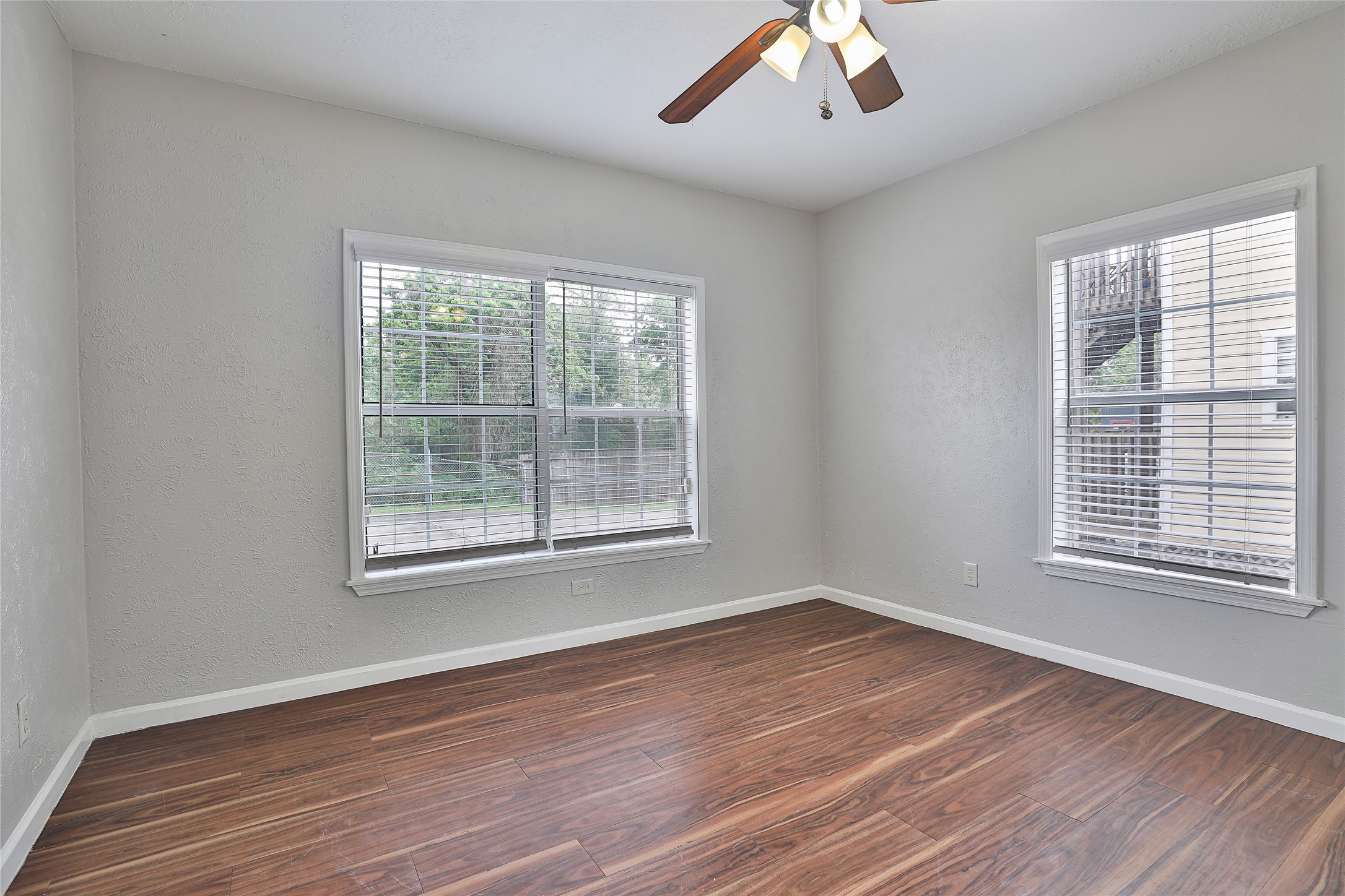 5009 Polk Street Houston, TX 77023 - Photo 10 of 16 a view of an empty room with wooden floor and a window