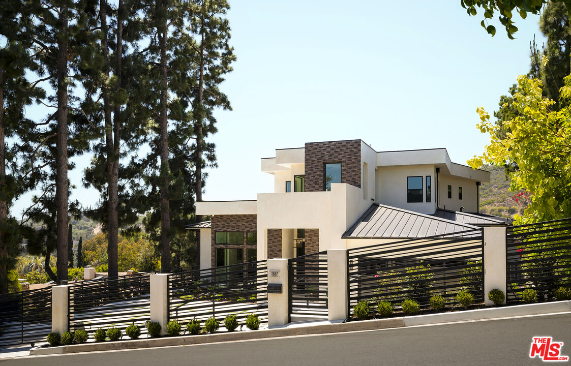 1367 Casiano Road Los Angeles, CA 90049 - Photo 1 of 26 a view of a house with many windows