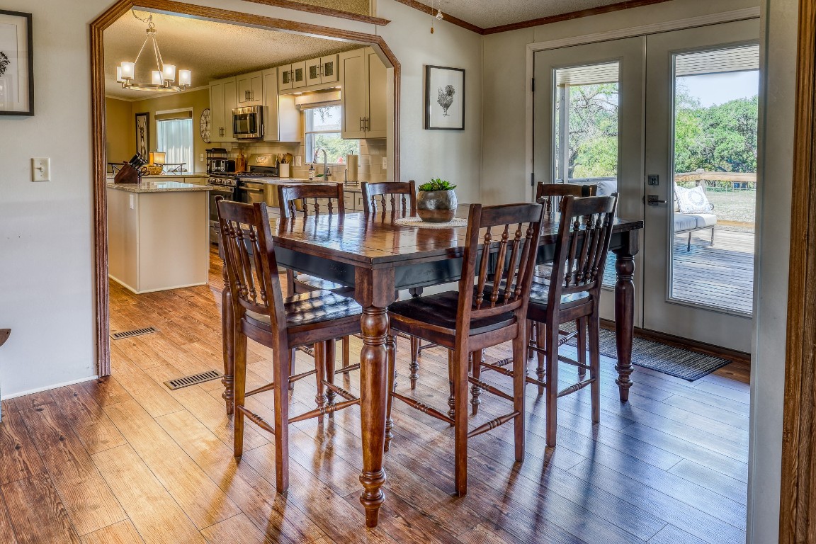 4991 County Road 416 Uvalde, TX 78801 - Photo 9 of 40 a view of a dining room with furniture and wooden floor