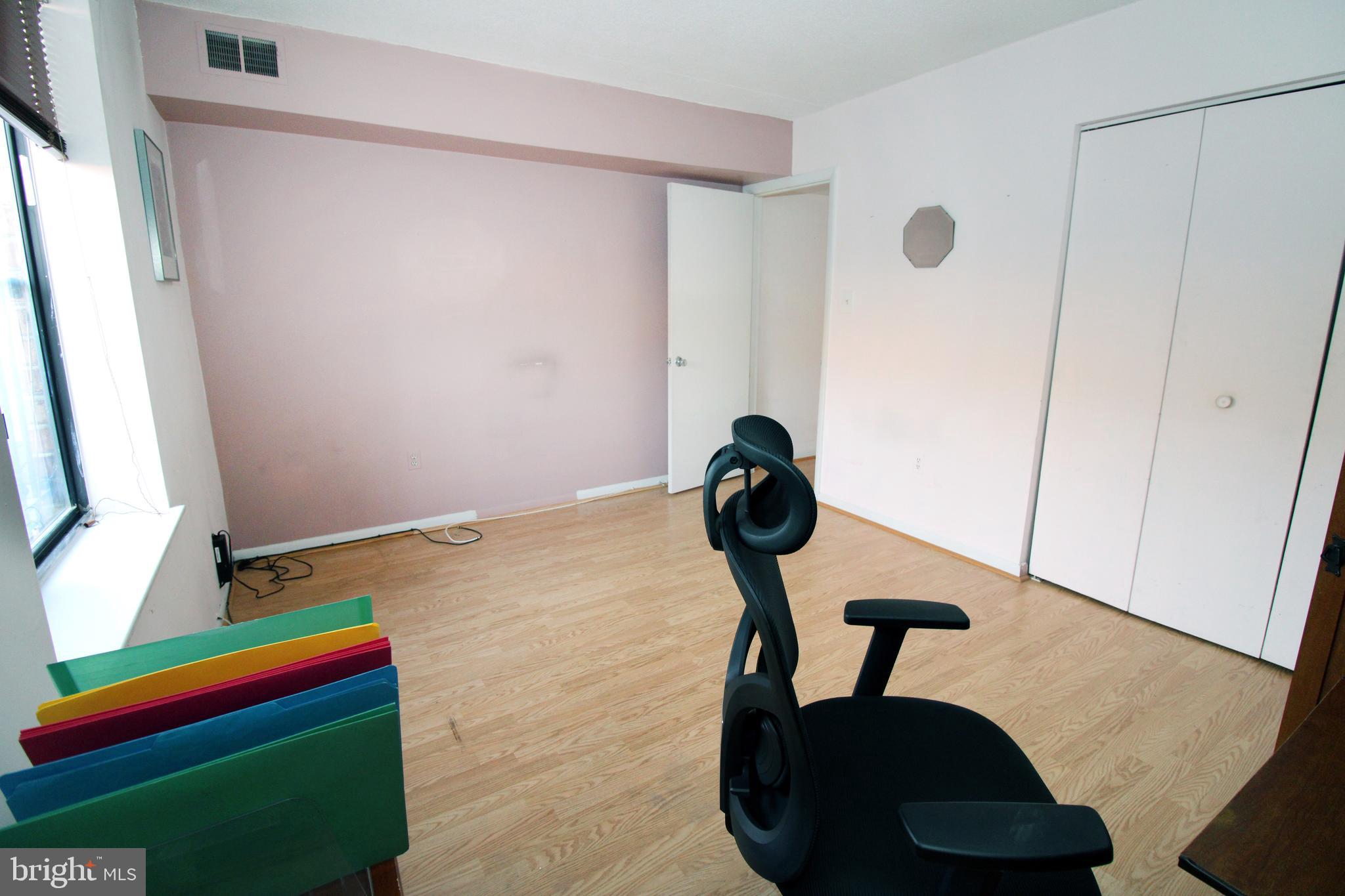 592 Brummel Court Northwest, Unit 592 Washington, DC 20012 - Photo 11 of 13 a bedroom with a bed and a mirror