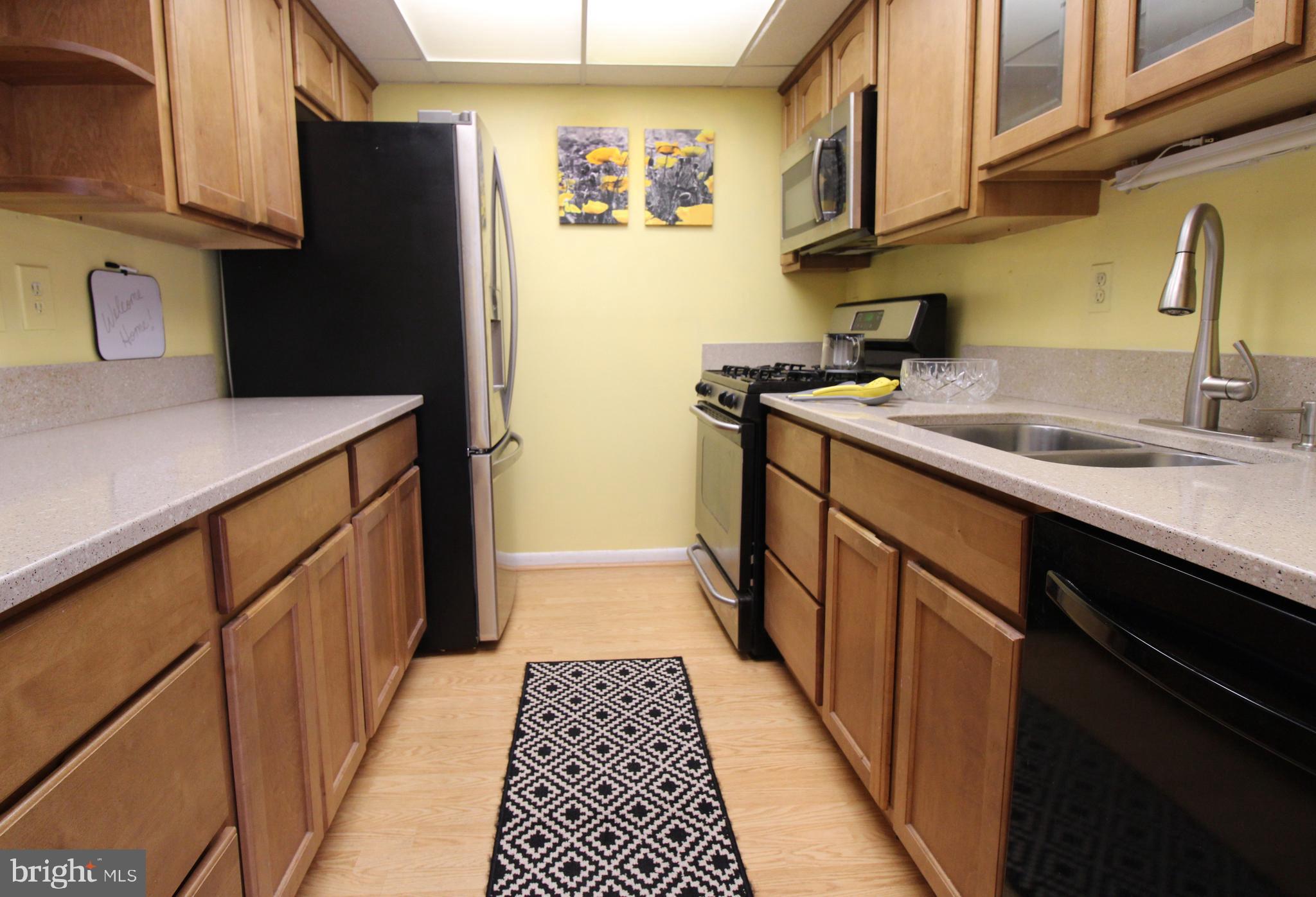 592 Brummel Court Northwest, Unit 592 Washington, DC 20012 - Photo 2 of 13 a kitchen with stainless steel appliances a sink stove and refrigerator