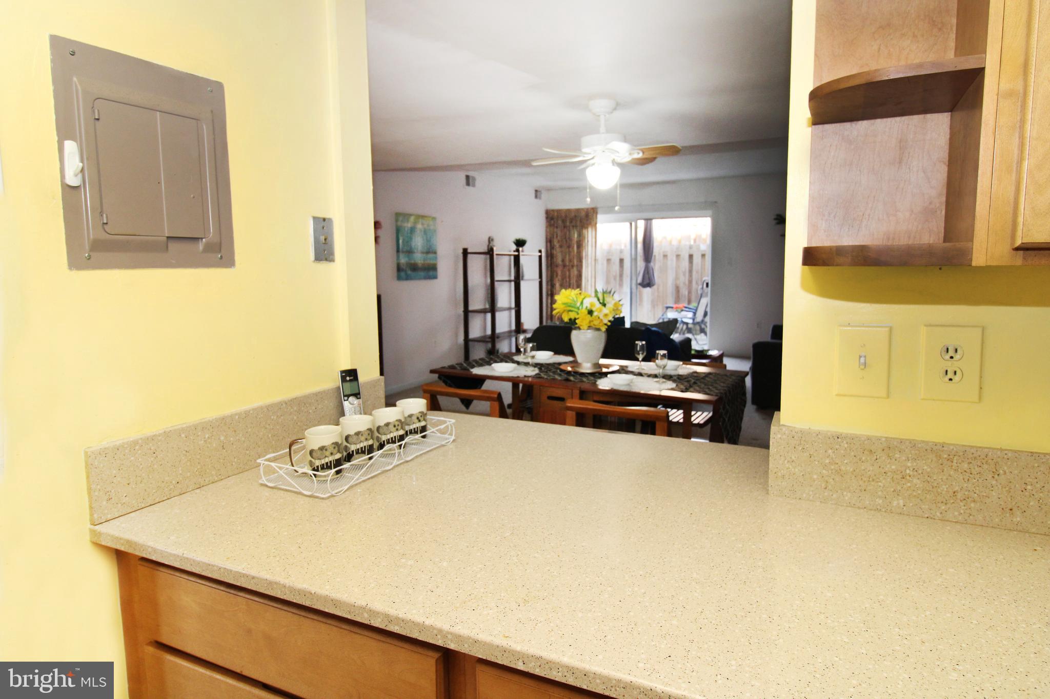592 Brummel Court Northwest, Unit 592 Washington, DC 20012 - Photo 3 of 13 a view of a kitchen with dining table and chairs