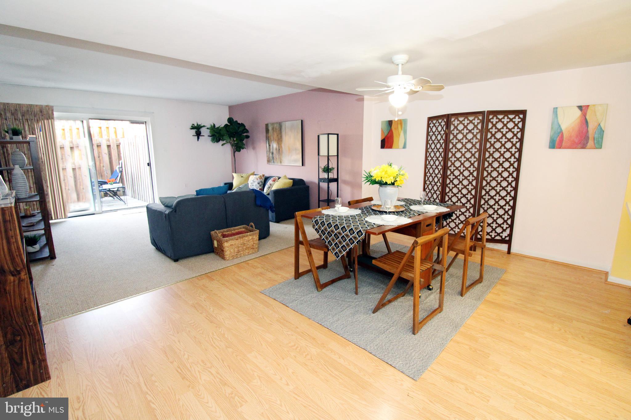 592 Brummel Court Northwest, Unit 592 Washington, DC 20012 - Photo 6 of 13 a living room with furniture a dining table and a potted plant