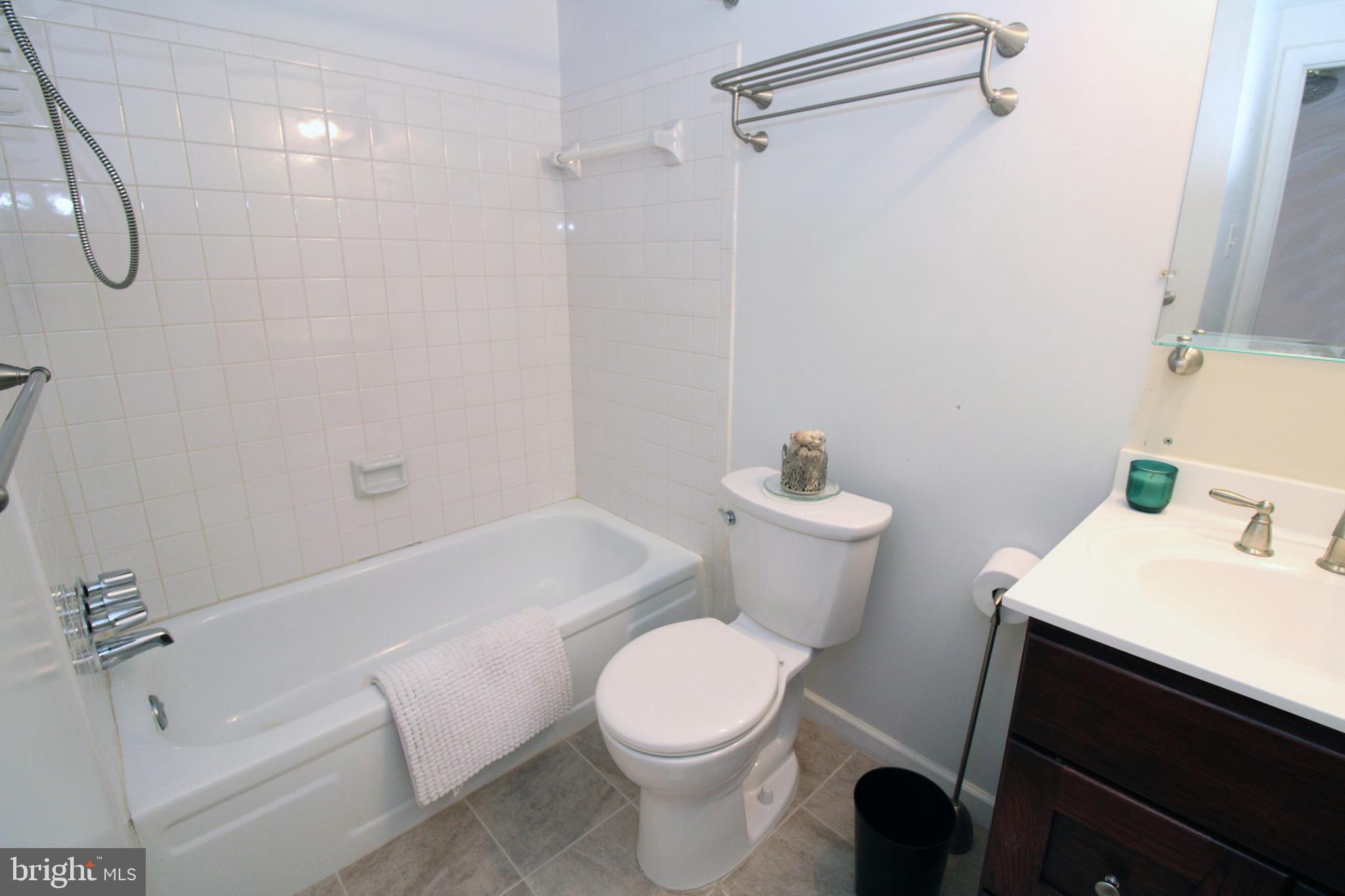 592 Brummel Court Northwest, Unit 592 Washington, DC 20012 - Photo 8 of 13 a white toilet sitting next to a bath tub