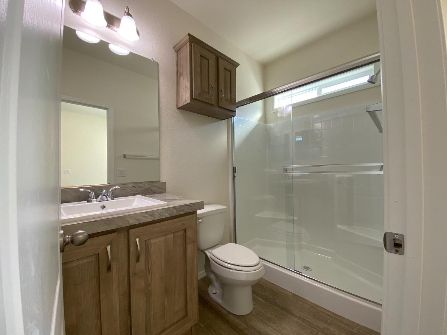 5812 Cedars Road, Unit 13 Redding, CA 96001 - Photo 12 of 12 a bathroom with a granite countertop sink toilet and shower