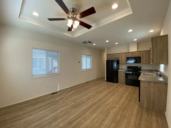 a large kitchen with stainless steel appliances granite countertop a stove and a refrigerator