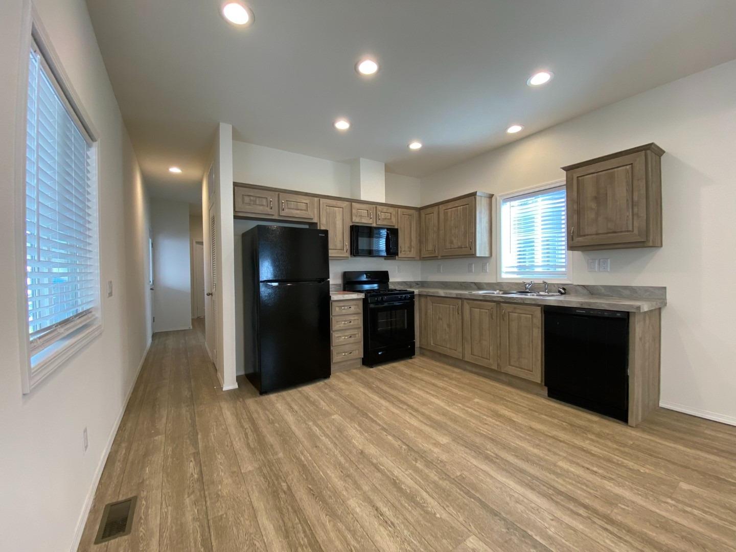 5812 Cedars Road, Unit 13 Redding, CA 96001 - Photo 4 of 12 a kitchen with a refrigerator and a microwave