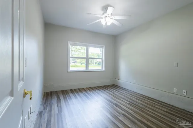 wooden floor in an empty room with a window