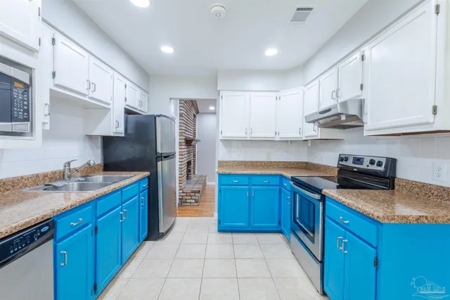 a kitchen with stainless steel appliances granite countertop a stove a sink dishwasher a refrigerator and a oven