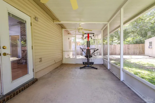 a view of a porch with chairs and backyard