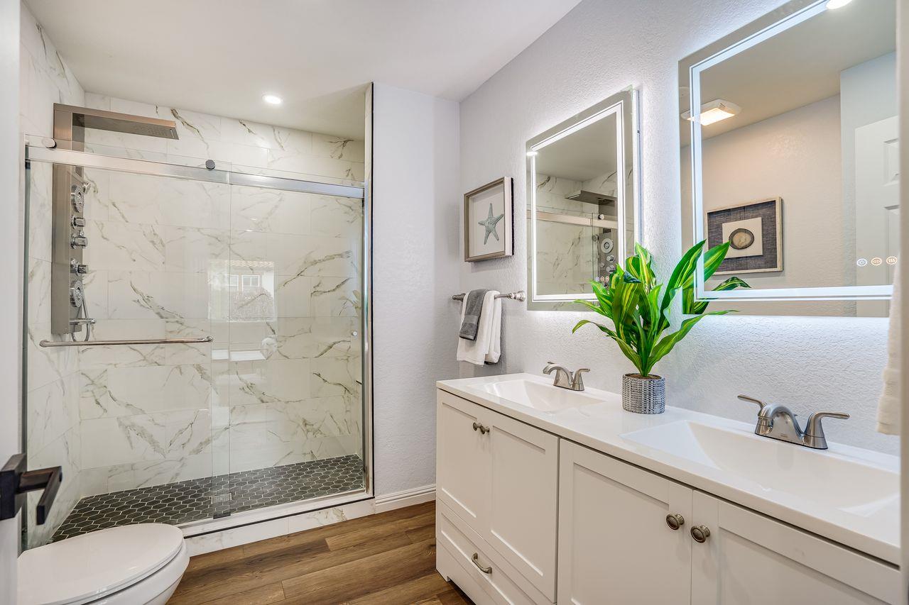6586 Broadacres Drive San Jose, CA 95120 - Photo 15 of 37 a bathroom with a sink a toilet and a mirror