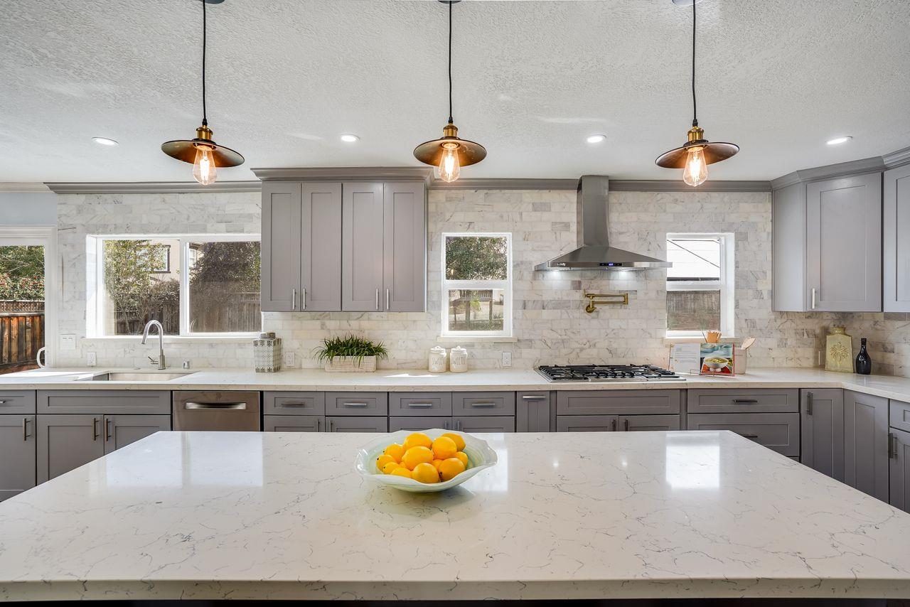 6586 Broadacres Drive San Jose, CA 95120 - Photo 6 of 37 a kitchen with stainless steel appliances granite countertop a sink a stove and a wooden floors