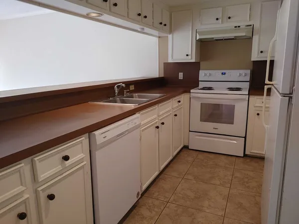 a utility room with cabinets washer and dryer