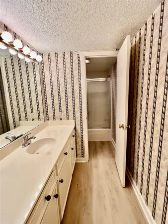 a spacious bathroom with a double vanity sink and a large mirror