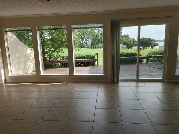 a view of an entryway with wooden floor and garden
