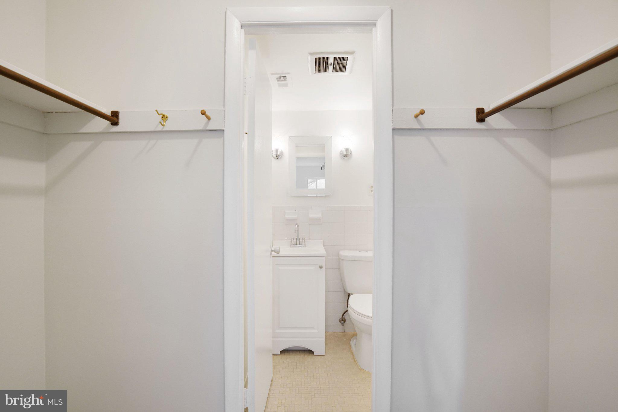5020 7th Road South, Unit 102 Arlington, VA 22204 - Photo 17 of 30 a bathroom with a granite countertop shower and a toilet