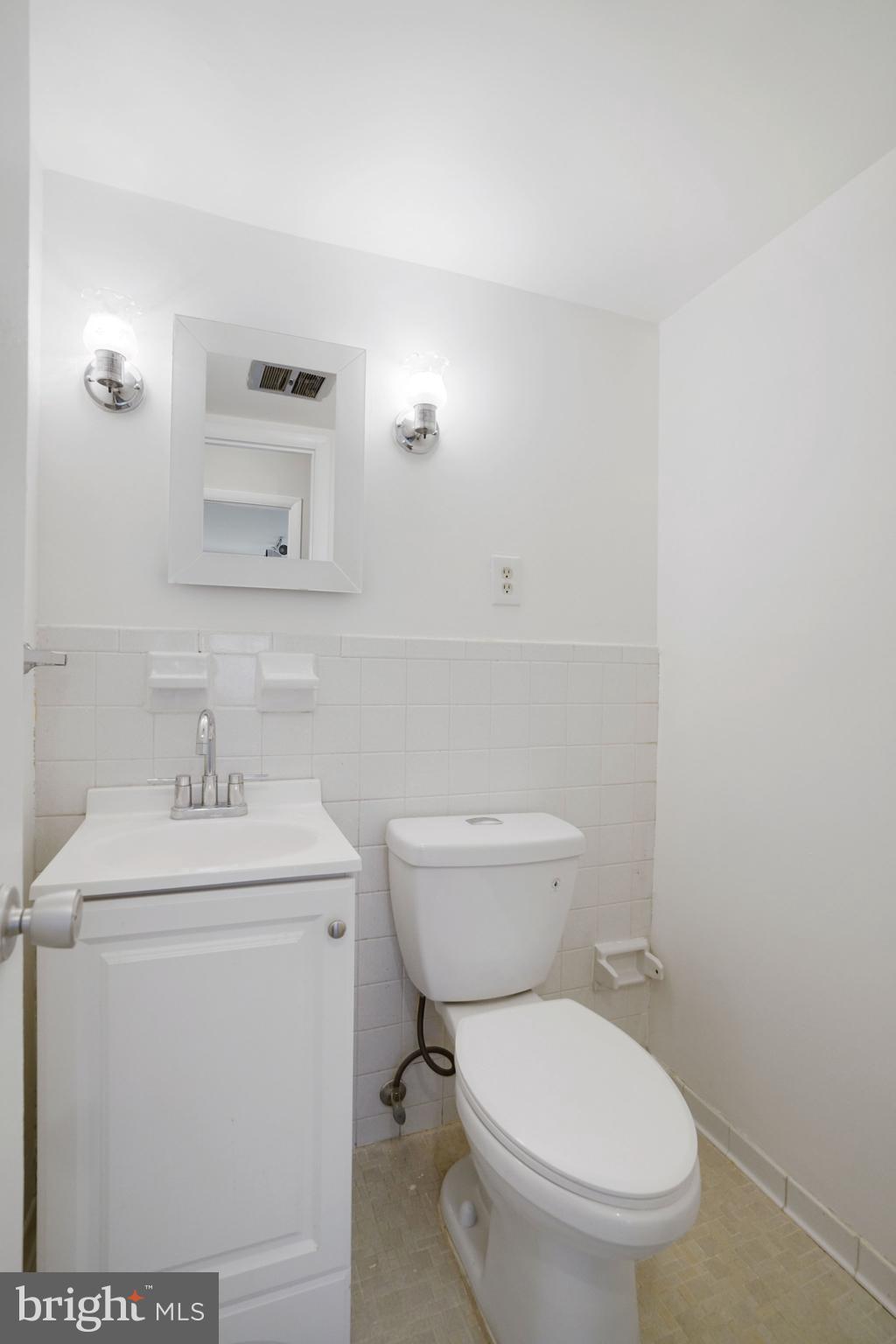 5020 7th Road South, Unit 102 Arlington, VA 22204 - Photo 19 of 30 a bathroom with a toilet a sink and mirror