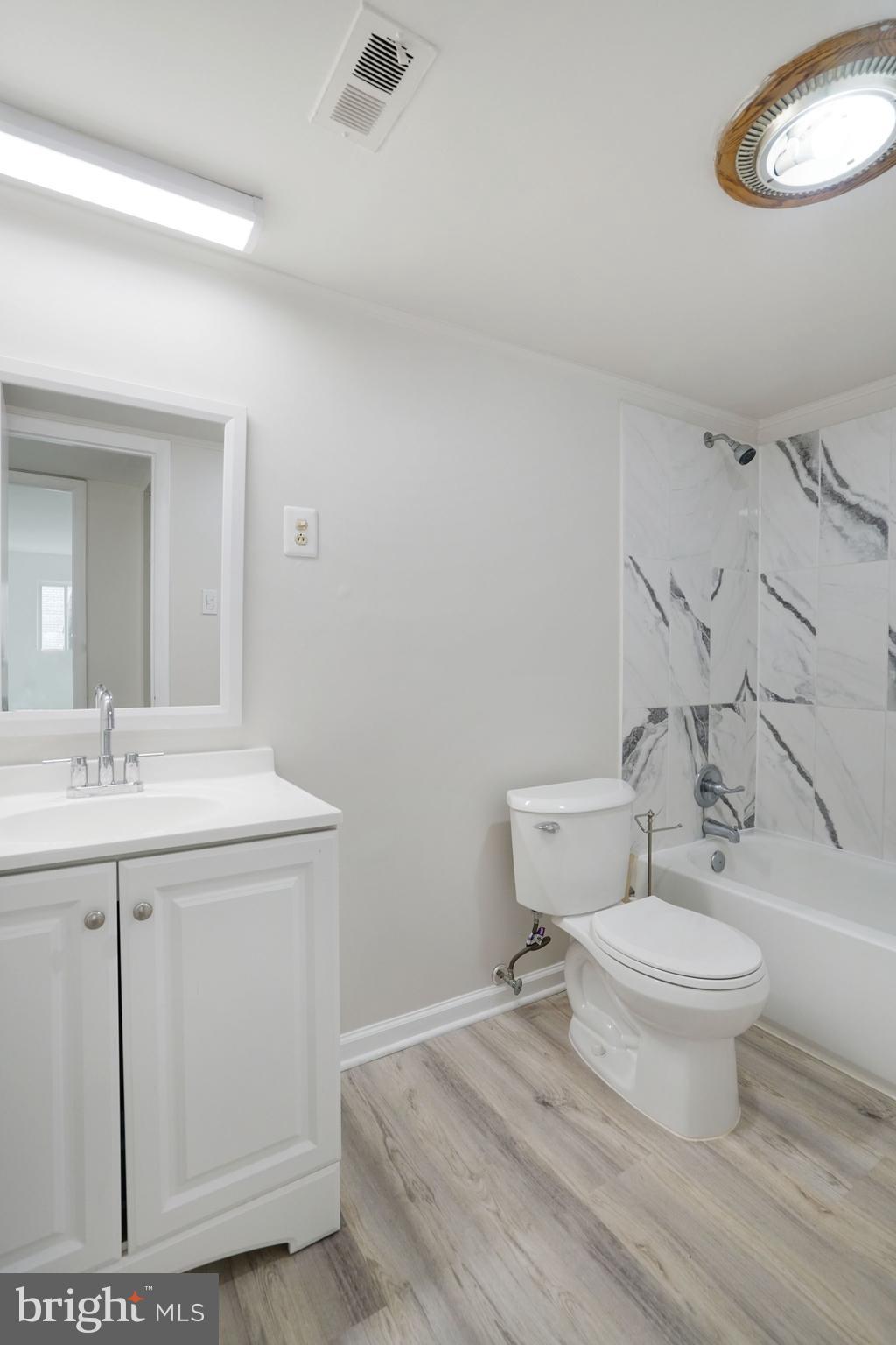 5020 7th Road South, Unit 102 Arlington, VA 22204 - Photo 20 of 30 a bathroom with a toilet a sink and mirror