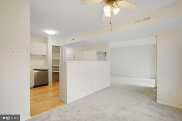a view of a kitchen with a sink and a refrigerator