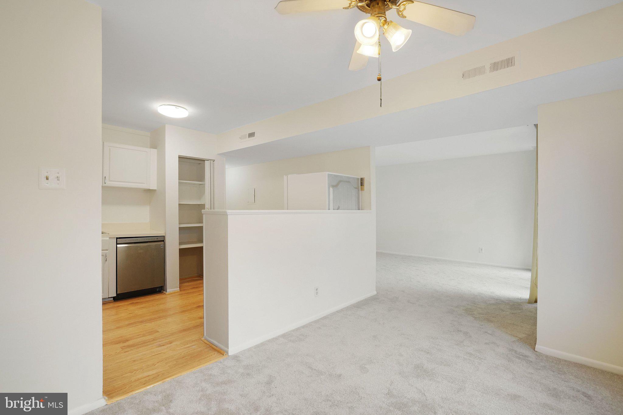 5020 7th Road South, Unit 102 Arlington, VA 22204 - Photo 4 of 30 a view of a kitchen with a sink and a refrigerator