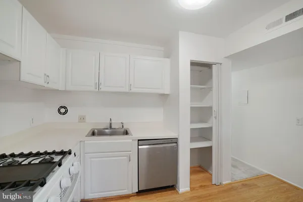 a kitchen with a sink and cabinets