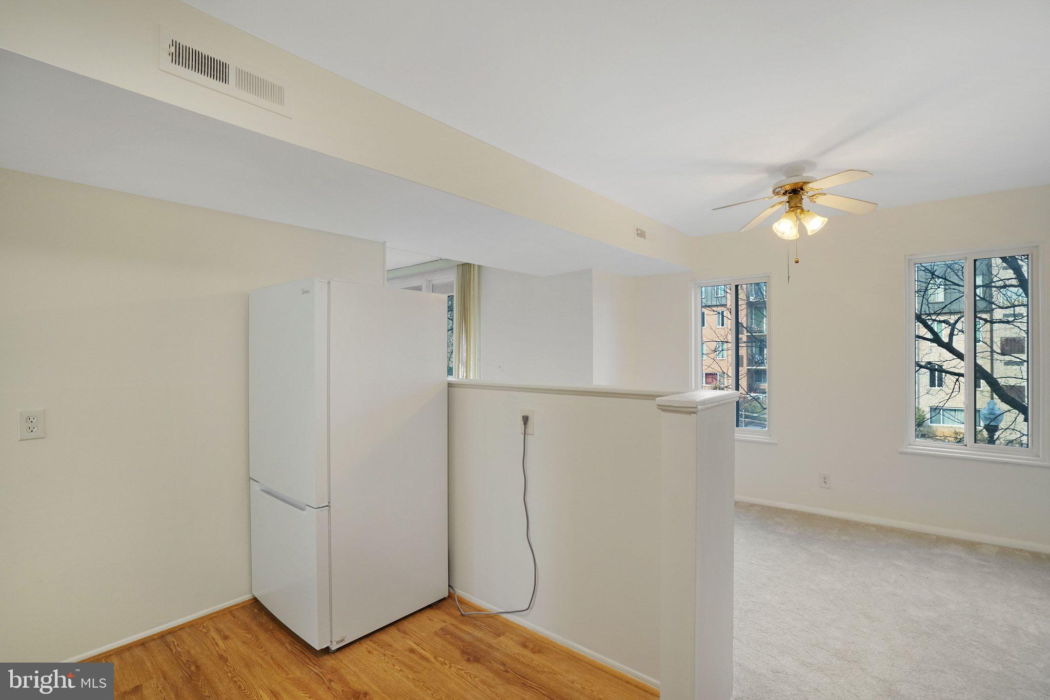 5020 7th Road South, Unit 102 Arlington, VA 22204 - Photo 7 of 30 a view of a room with wooden floor and a ceiling fan