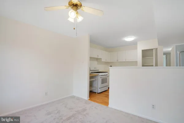 a kitchen with cabinets and wooden floor