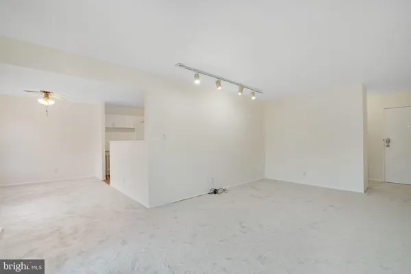 a view of an empty room with glass door