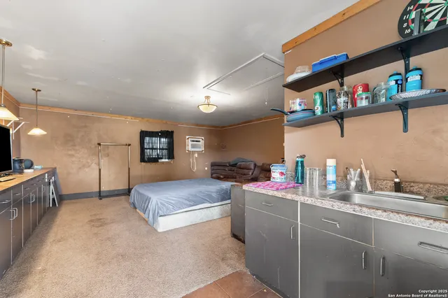 a spacious bedroom with a bed and a flat screen tv