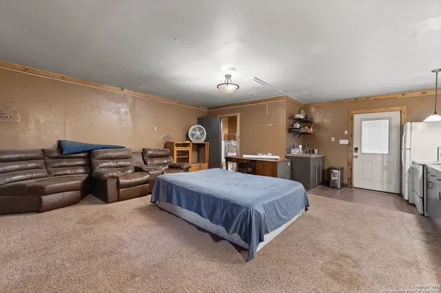 a spacious bedroom with a bed and a couch