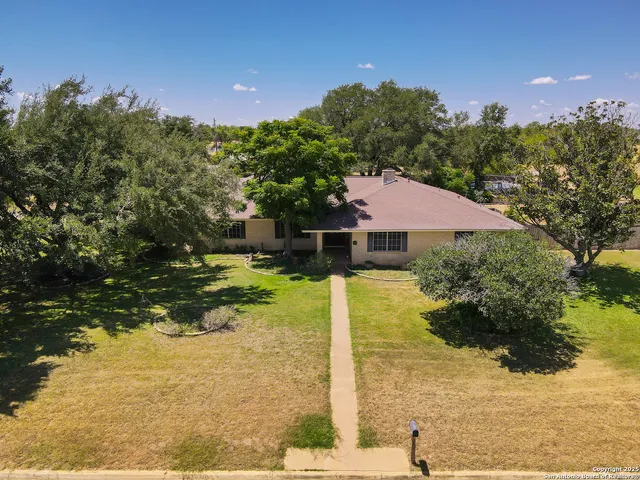 a view of a swimming pool with a yard