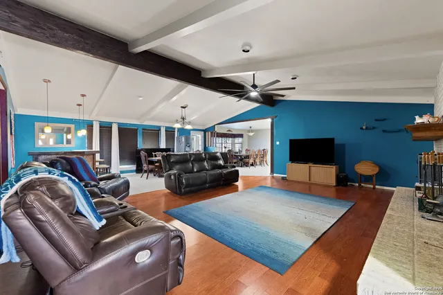 a living room with furniture fireplace and a flat screen tv