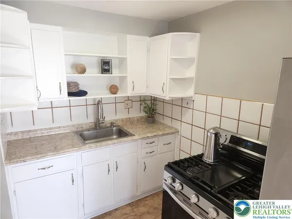 a kitchen with cabinets and appliances