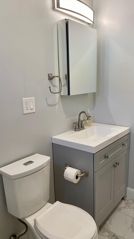 8 Groom Street, Unit 3 Boston, MA 02125 - Photo 3 of 3 a white toilet sitting next to a bathroom sink