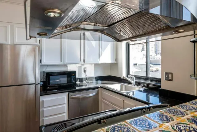 a kitchen with a refrigerator and a sink
