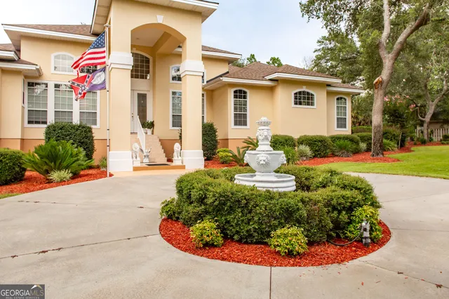 a view of a garden with a house