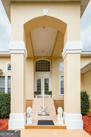 a front view of a house with a patio and a yard