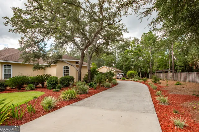 a view of a house with a yard and garage