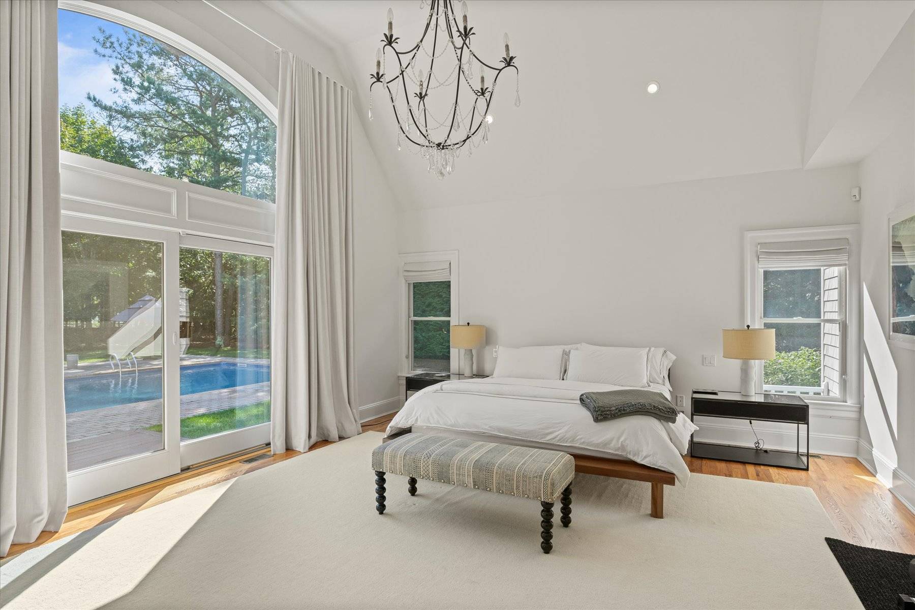 33 Post Fields Lane Quogue, NY 11959 - Photo 16 of 30 a spacious bedroom with a bed and a window