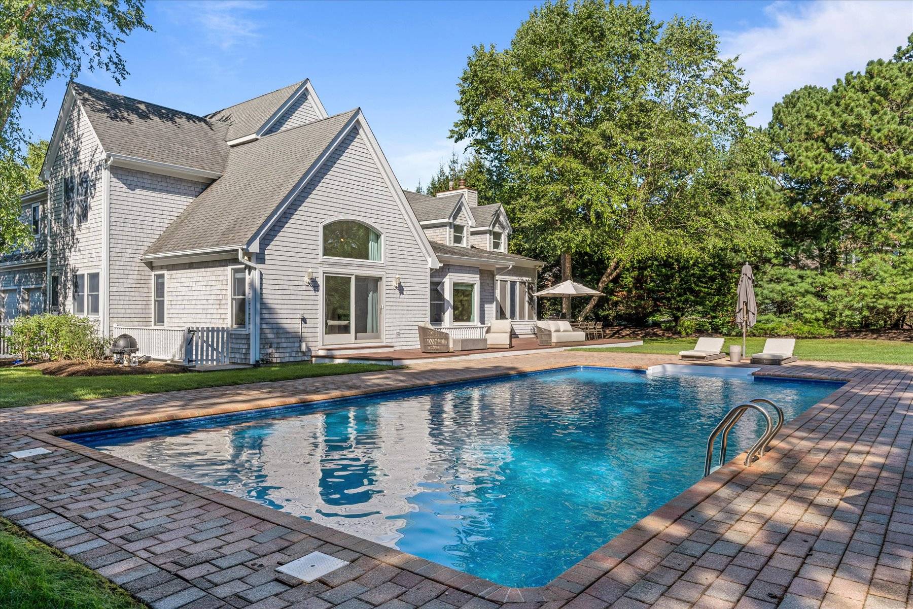 33 Post Fields Lane Quogue, NY 11959 - Photo 21 of 30 a front view of a house with garden