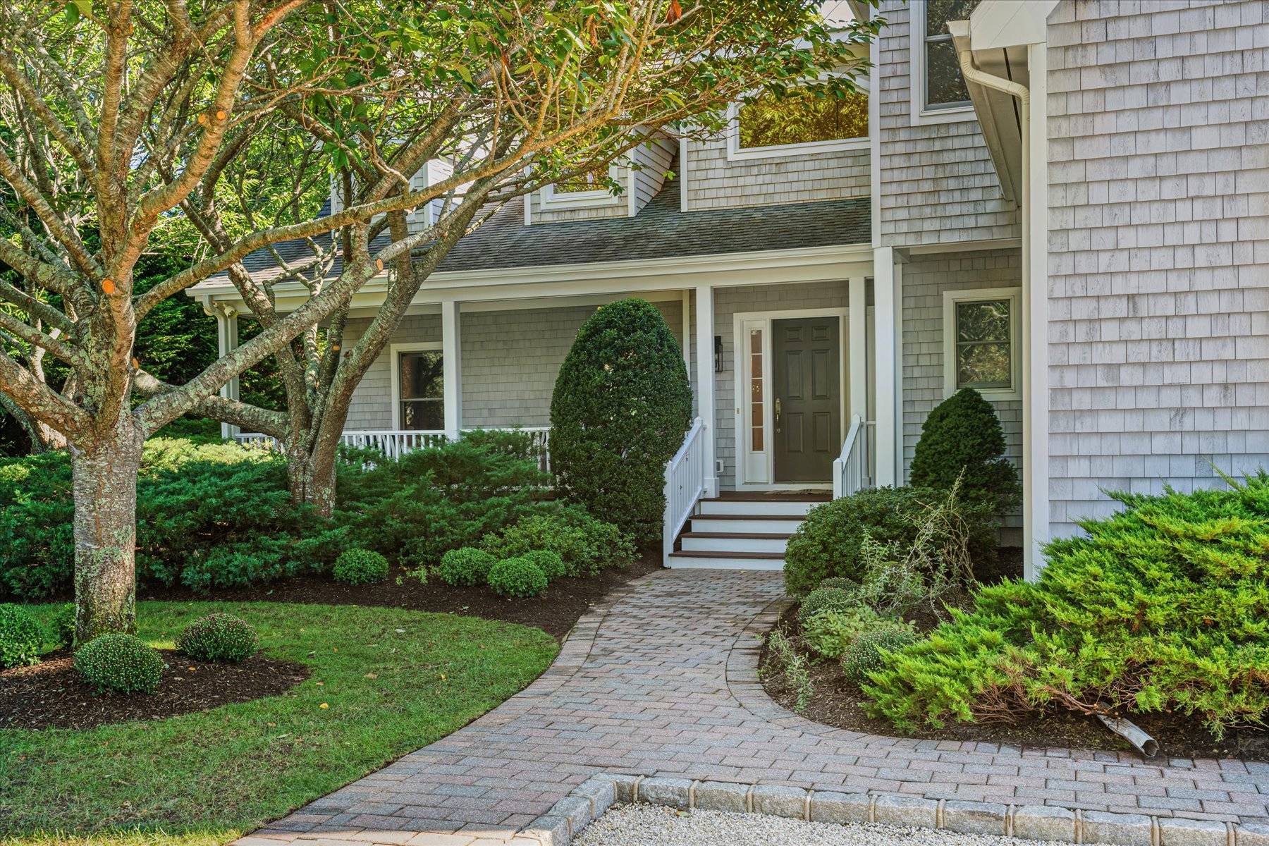 33 Post Fields Lane Quogue, NY 11959 - Photo 3 of 30 a front view of a house with garden