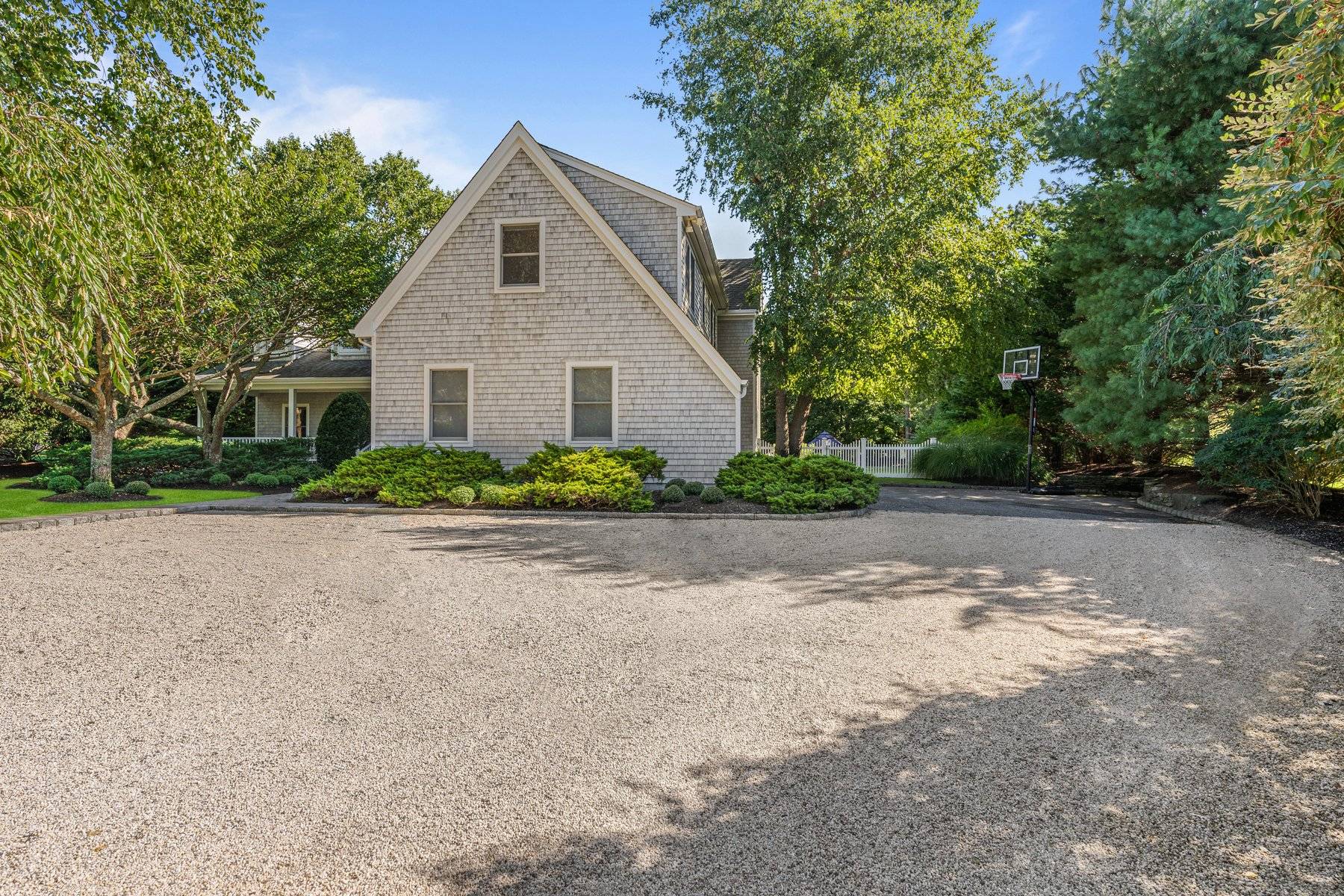 33 Post Fields Lane Quogue, NY 11959 - Photo 4 of 30 a front view of house with yard and trees around