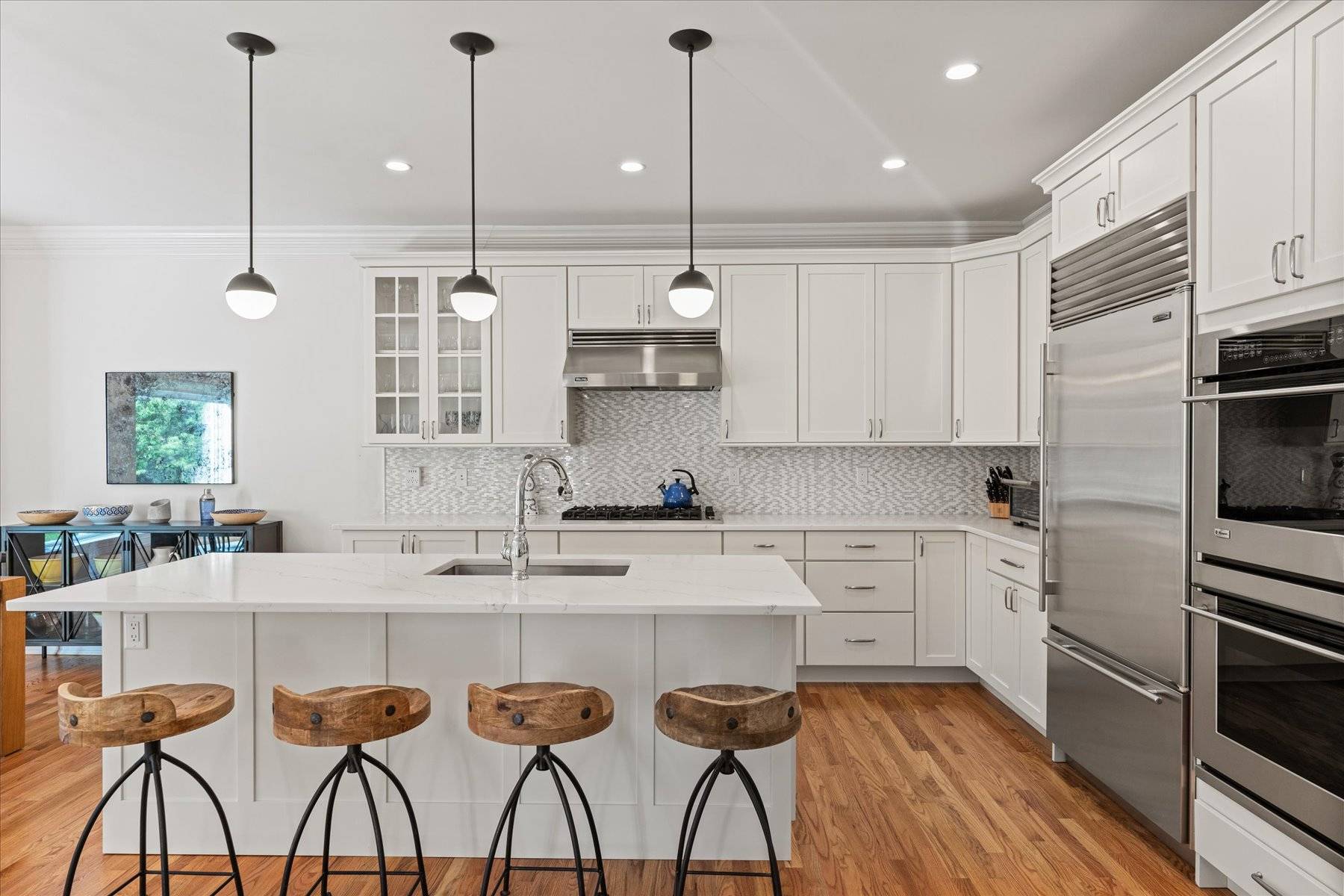33 Post Fields Lane Quogue, NY 11959 - Photo 10 of 30 a kitchen with stainless steel appliances granite countertop a sink a stove a refrigerator and island with wooden floor