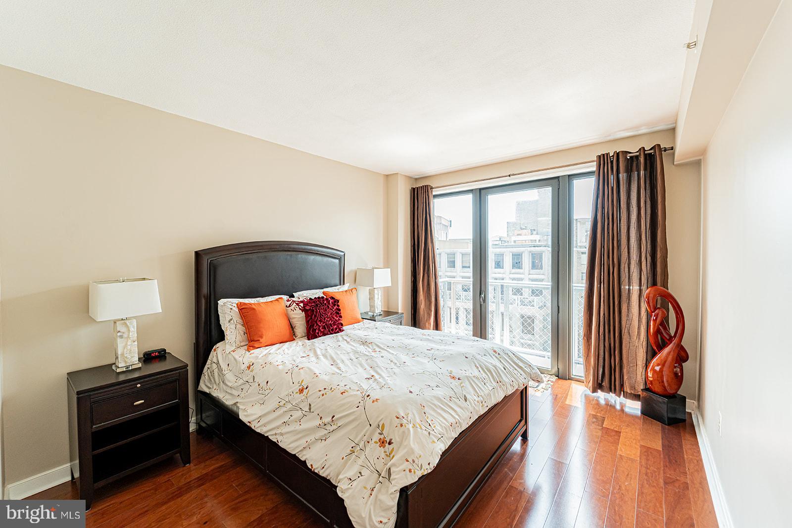 631 D Street Northwest, Unit 1231 Washington, DC 20004 - Photo 12 of 48 a bedroom with a bed and a lamp next to a window