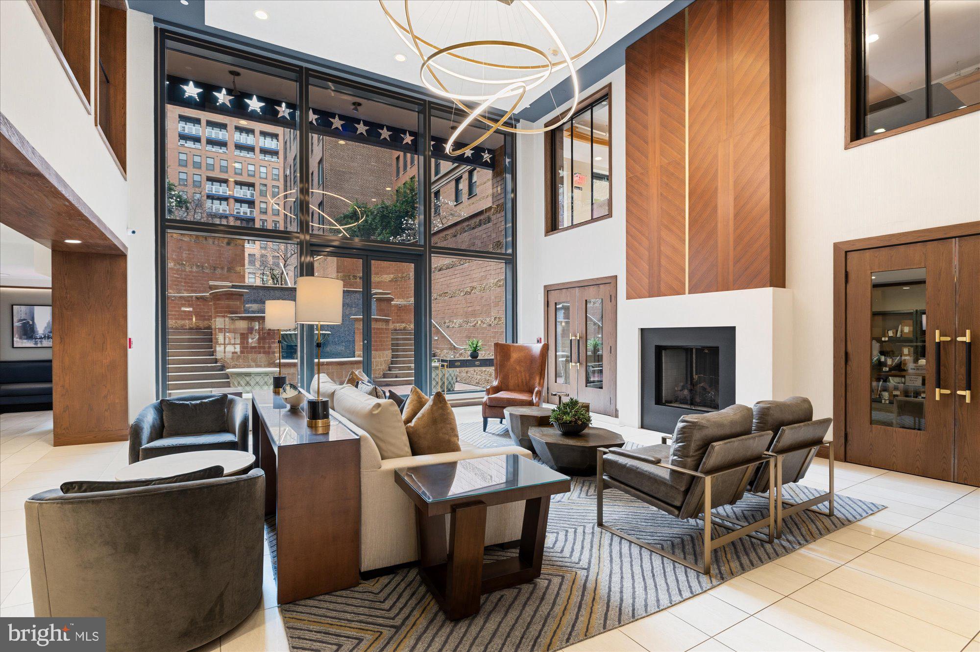 631 D Street Northwest, Unit 1231 Washington, DC 20004 - Photo 44 of 48 a living room with furniture a fireplace and floor to ceiling windows